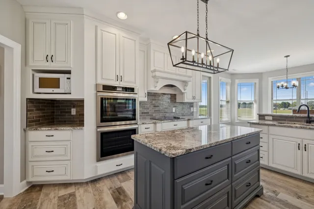 a view of a livingroom with wooden floor and a fireplace