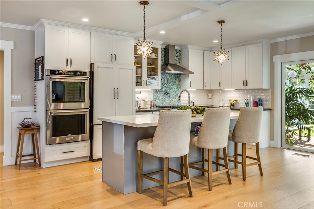 2505 Vail Avenue Redondo Beach, CA 90278 - Photo 23 of 41 a kitchen with stainless steel appliances kitchen island granite countertop a dining table chairs and white cabinets
