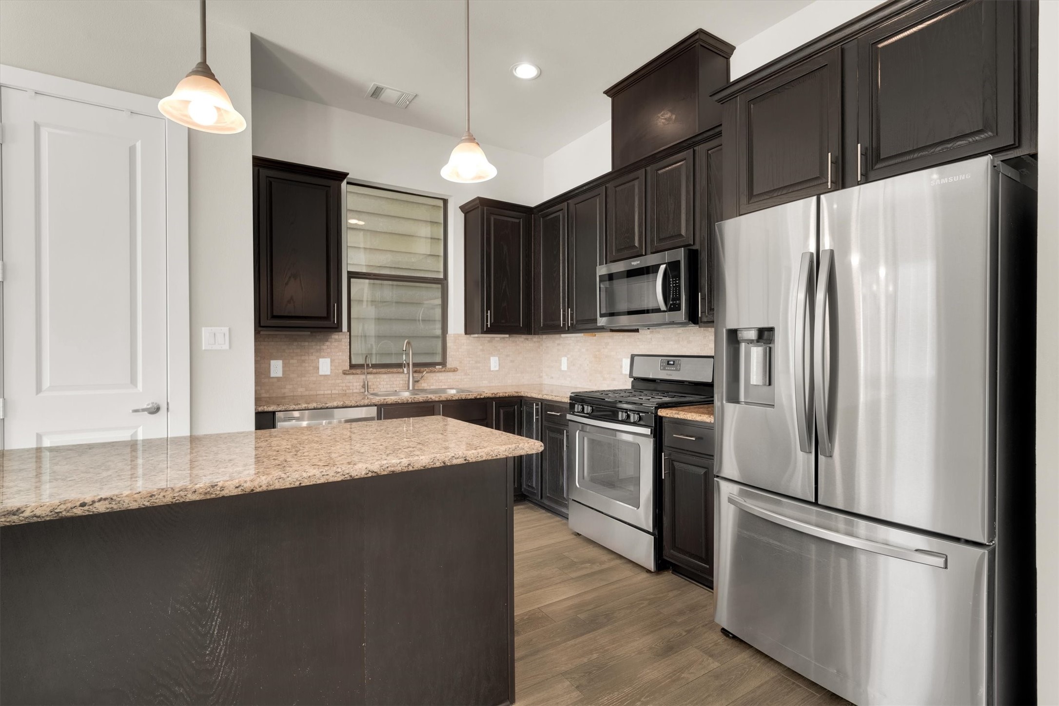 9405 Blalock Tree Court Houston, TX 77080 - Photo 15 of 39 a kitchen with stainless steel appliances granite countertop a refrigerator a stove a sink and a microwave