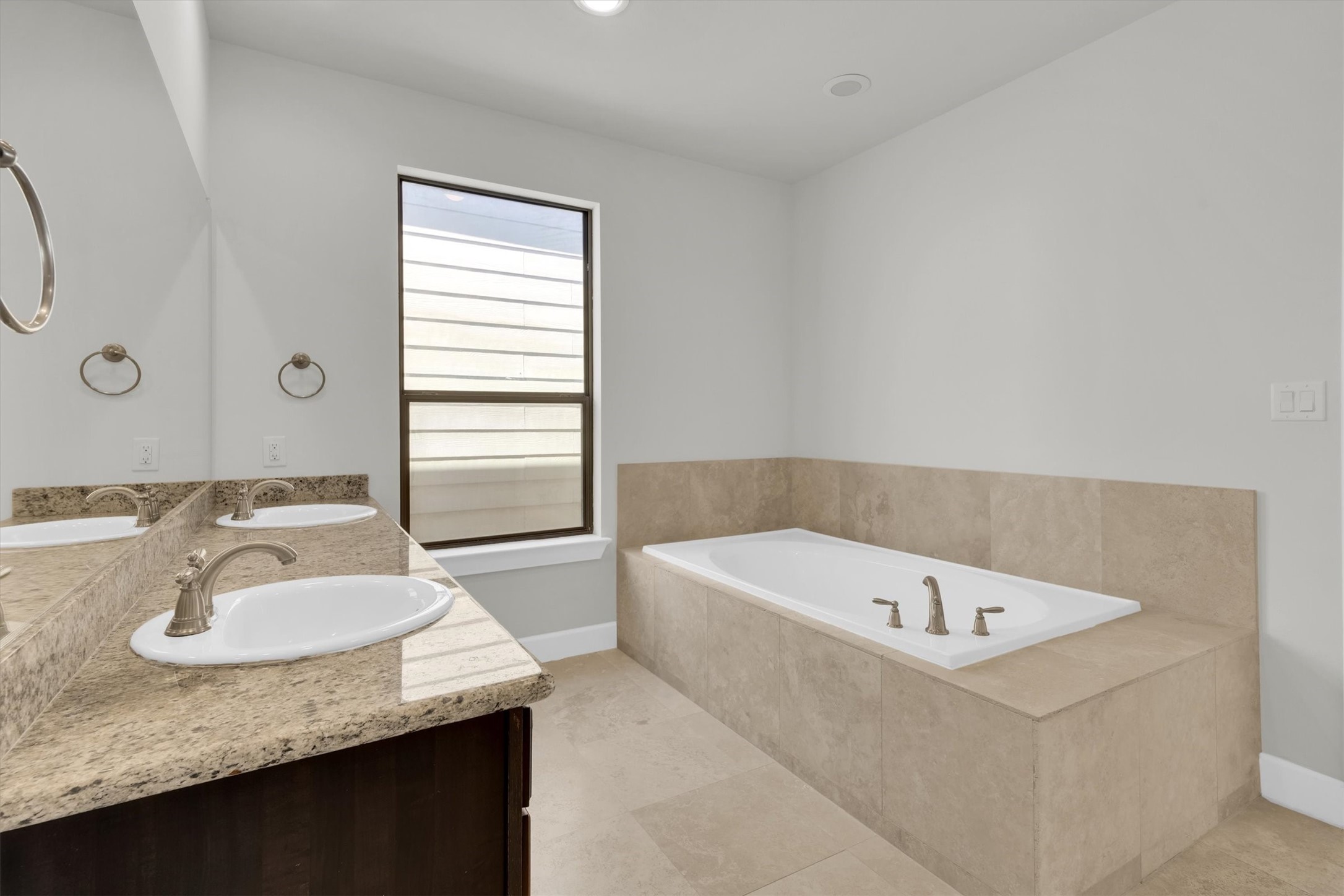 9405 Blalock Tree Court Houston, TX 77080 - Photo 27 of 39 a bathroom with a granite countertop sink and a bathtub