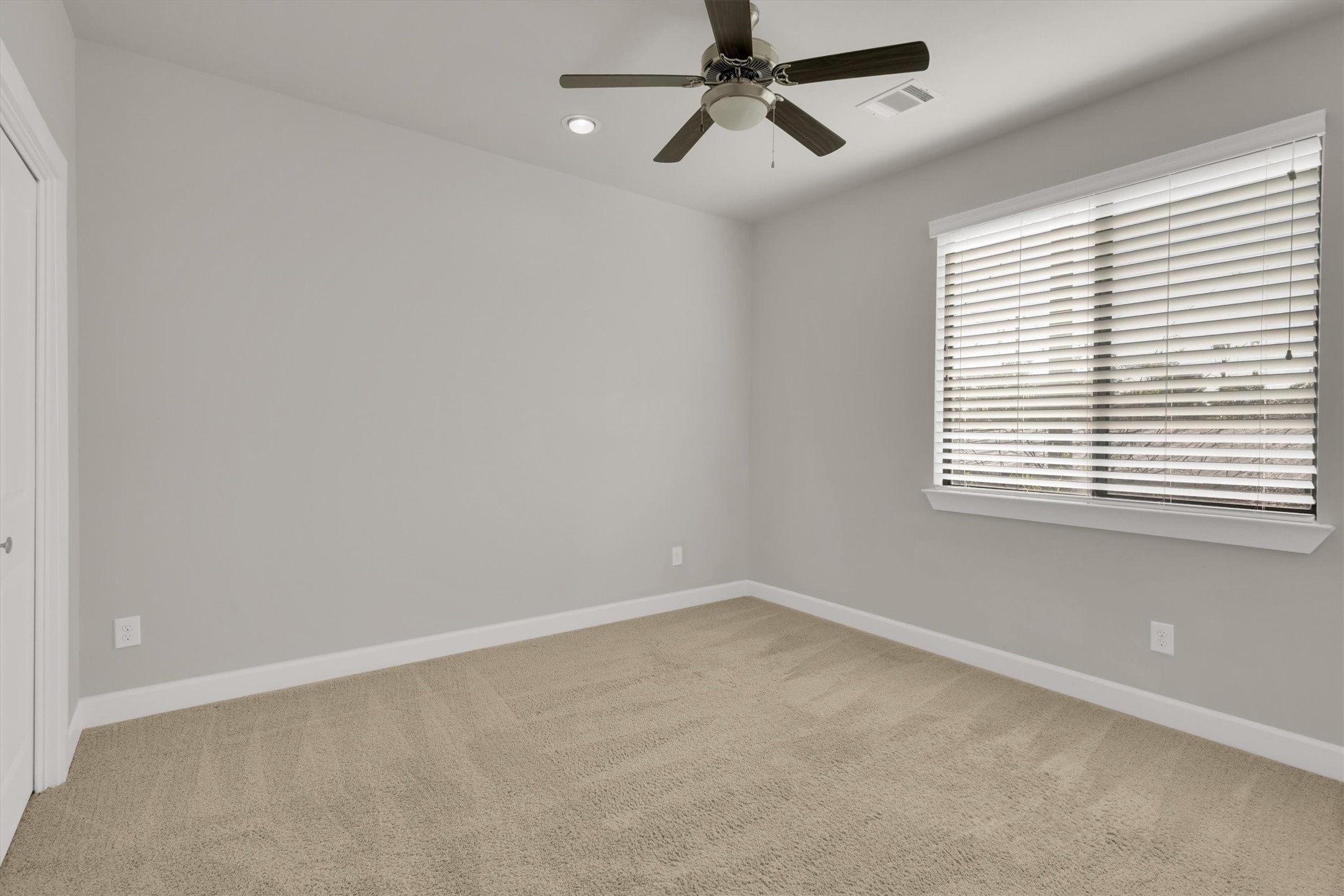 9405 Blalock Tree Court Houston, TX 77080 - Photo 30 of 39 an empty room with a window and a fan