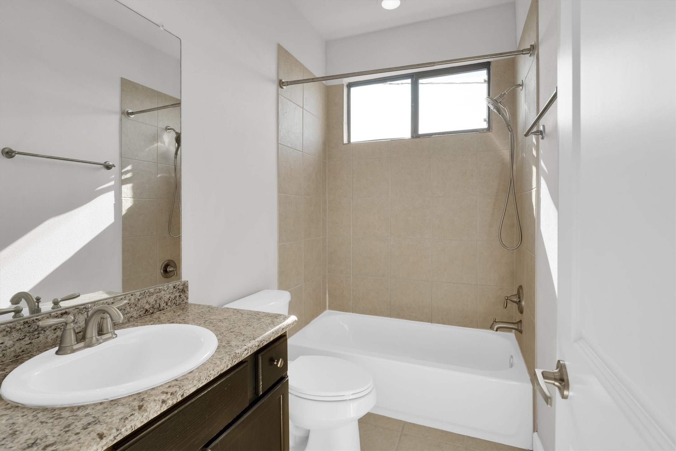 9405 Blalock Tree Court Houston, TX 77080 - Photo 32 of 39 a bathroom with a granite countertop sink toilet a mirror and shower