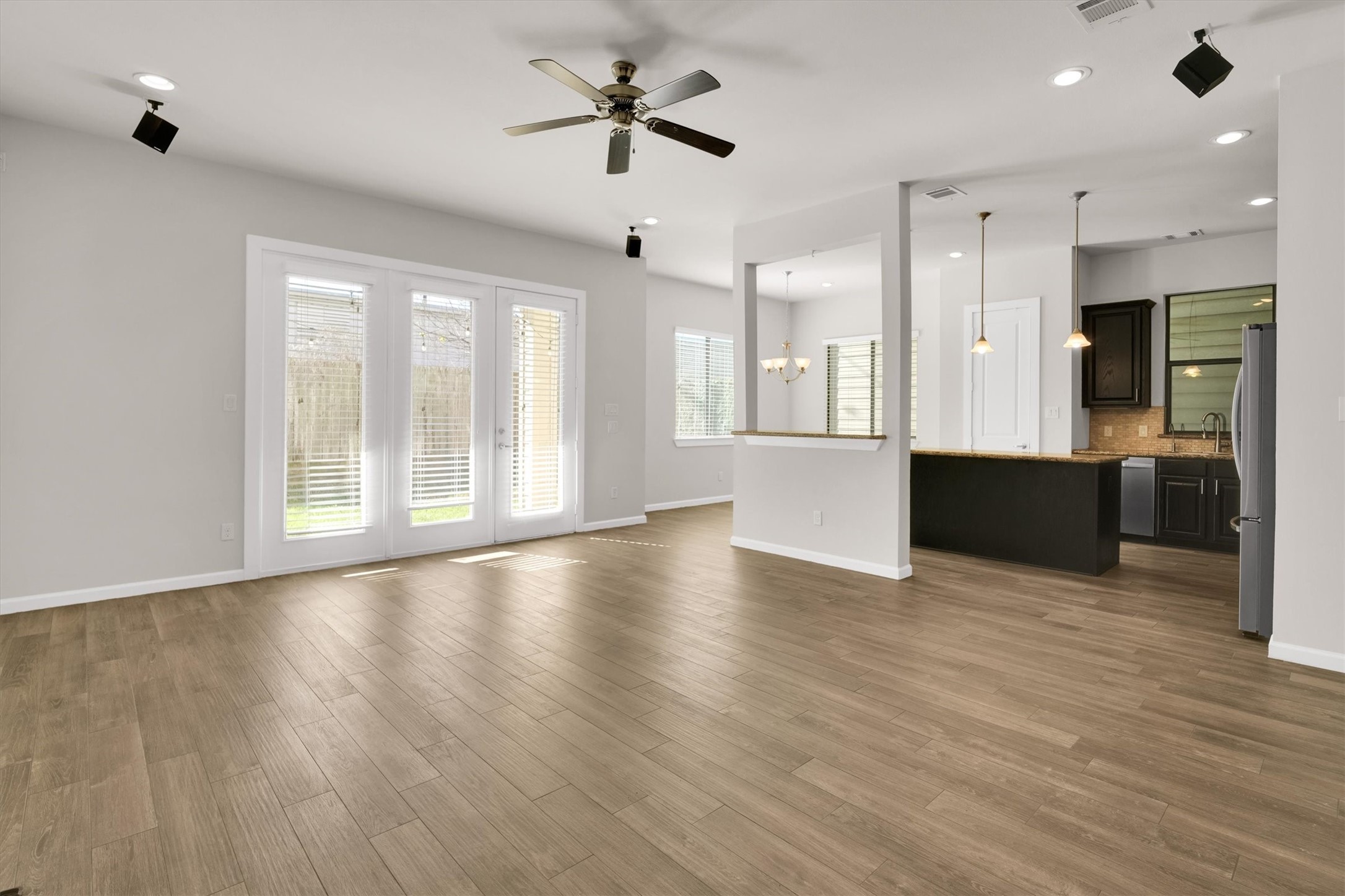 9405 Blalock Tree Court Houston, TX 77080 - Photo 7 of 39 a view of an empty room with window and wooden floor
