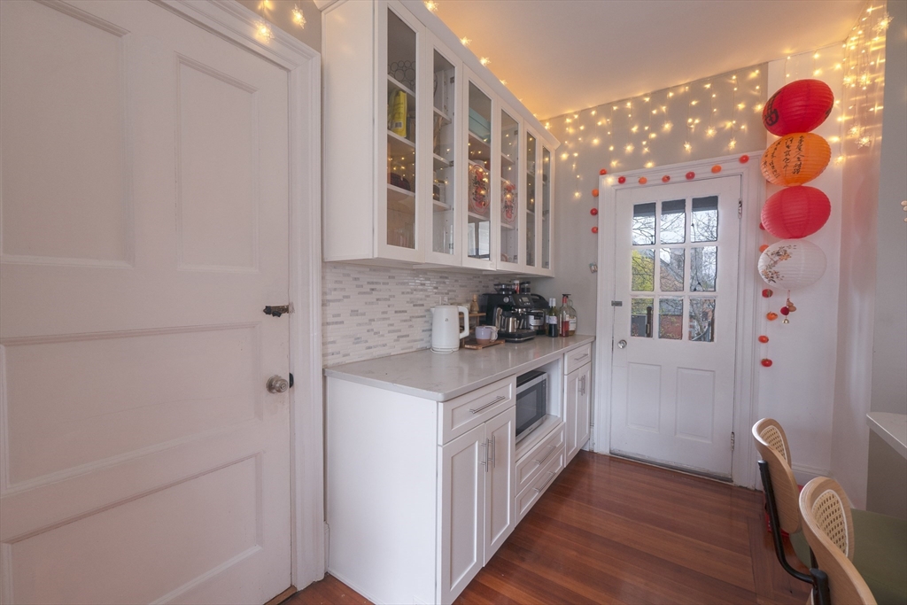 11 Wayne Street Boston, MA 02121 - Photo 19 of 27 a kitchen with stainless steel appliances granite countertop a stove and cabinets