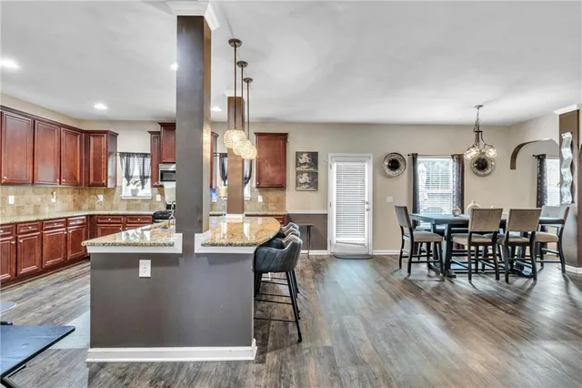 a large kitchen with a table and chairs