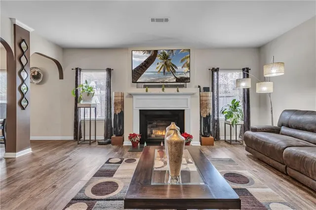a living room with furniture a couch and wooden floor