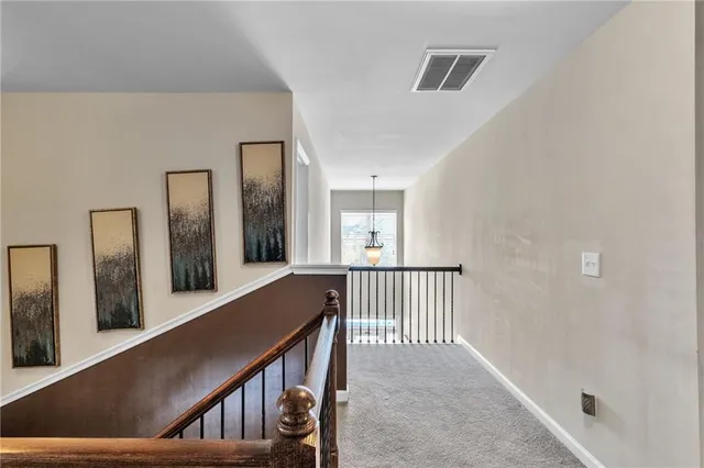 a view of a room that has a couch and a dresser in it