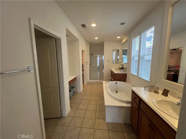 a bathroom with a double vanity sink toilet and shower
