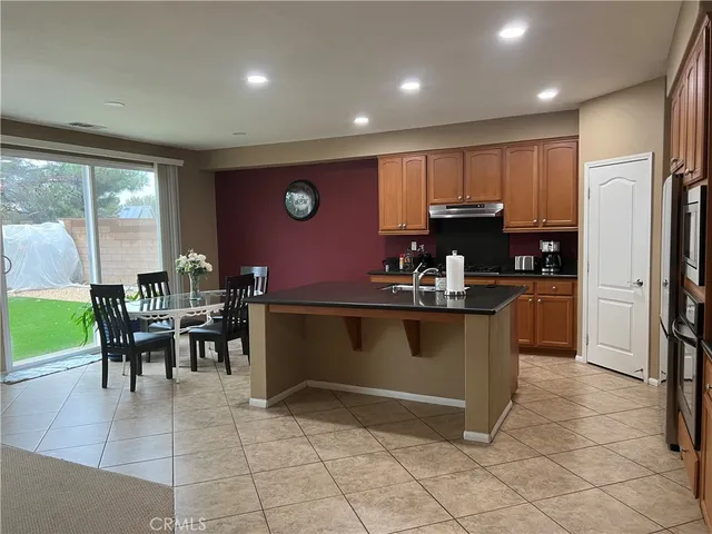 a kitchen with kitchen island granite countertop cabinets and refrigerator