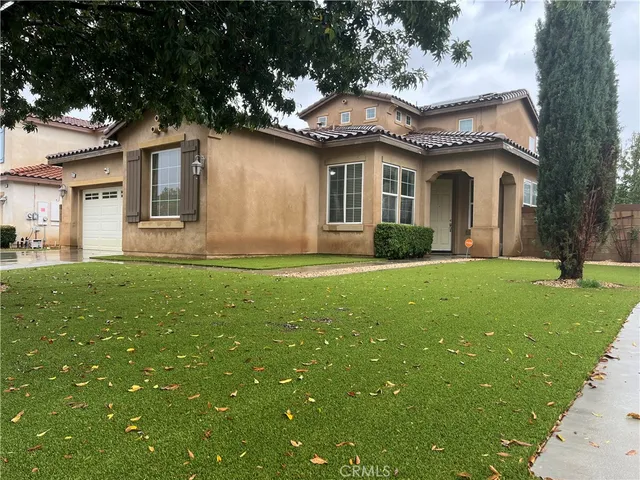 a front view of house with yard and green space