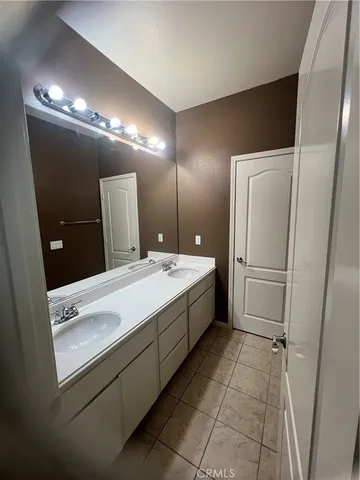 a bathroom with a double vanity sink and a mirror