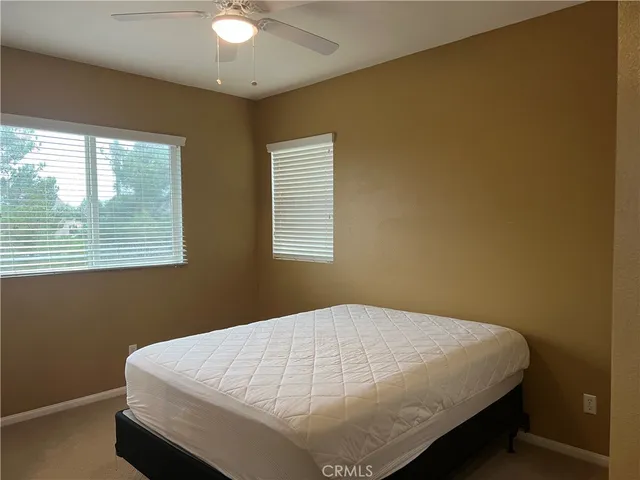 a bed sitting in a bedroom next to a window
