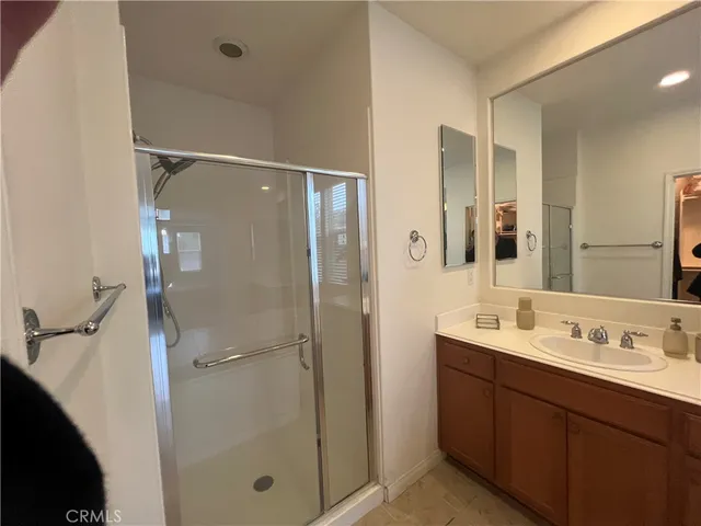 a bathroom with a double vanity sink mirror double and shower