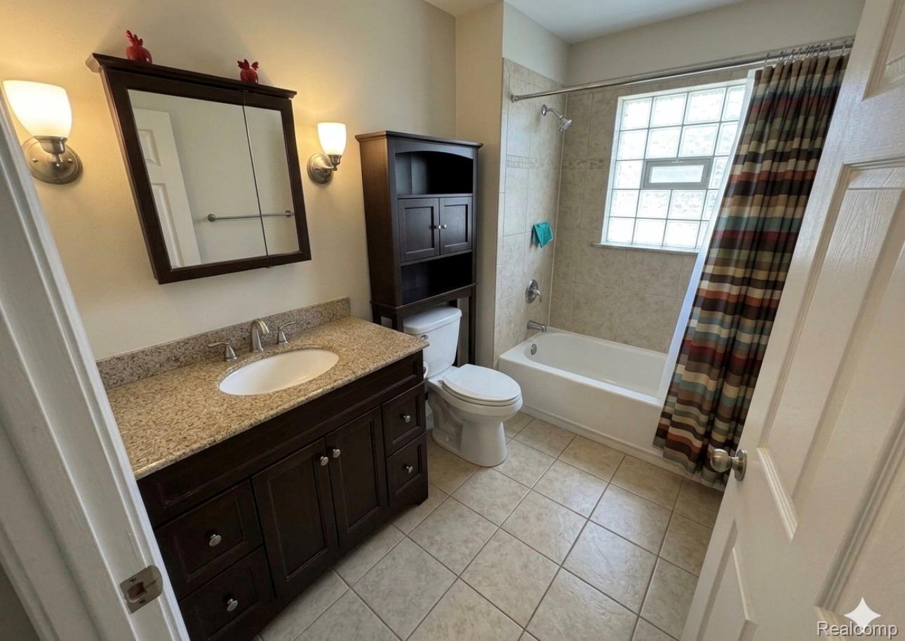 18418 Edinborough Road Detroit, MI 48219 - Photo 12 of 25 Full bath with shower / tub combo, vanity, and light tile patterned floors