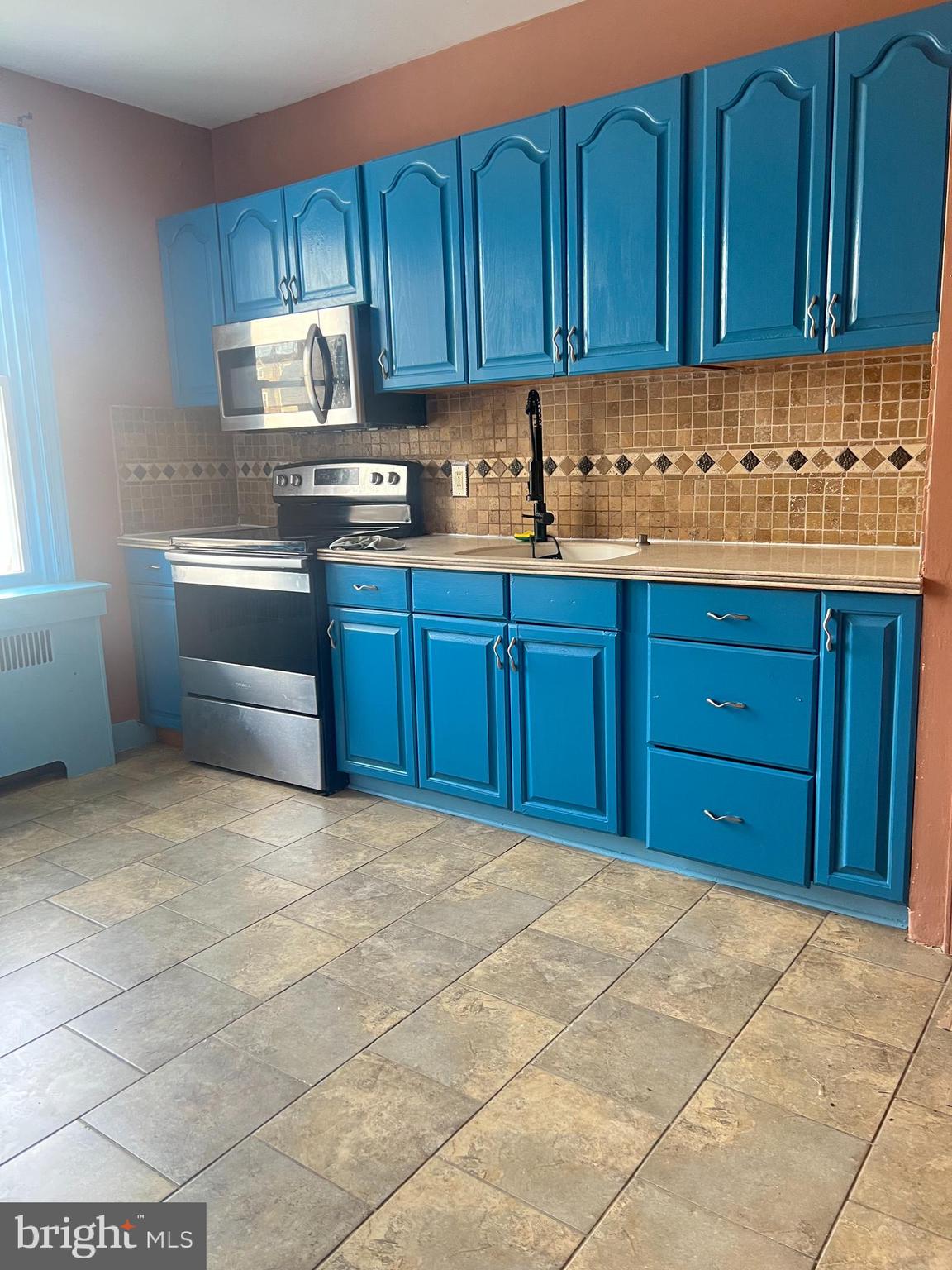 3303 Glenview Street Philadelphia, PA 19149 - Photo 5 of 7 a kitchen with granite countertop a cabinets and wooden floor