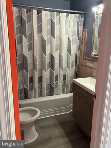 a bathroom with a toilet and a shower curtain