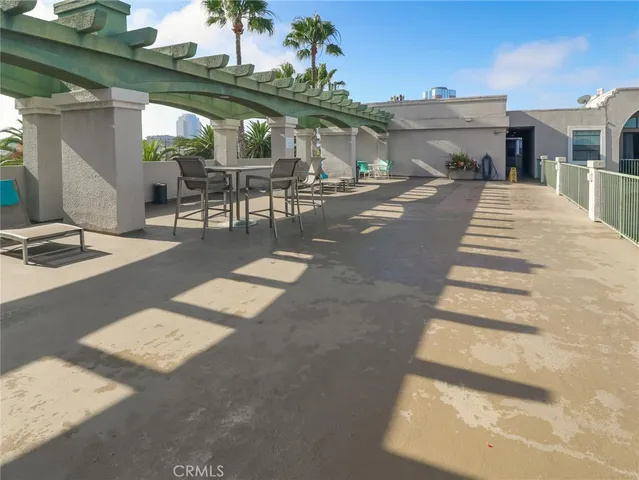 a view of a patio with a table and chairs