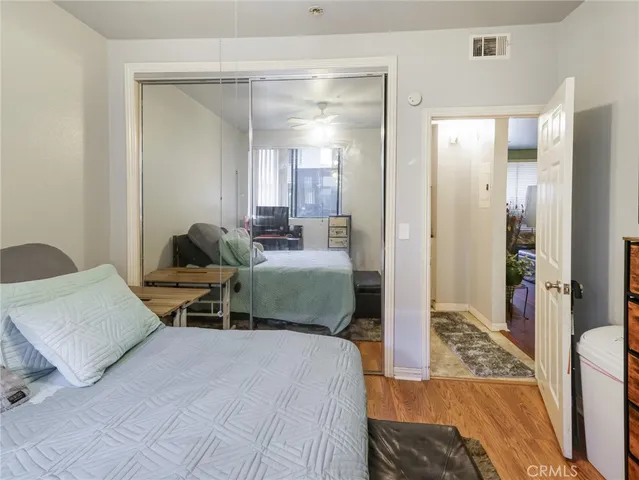a bedroom with a bed a couch and a view of living room