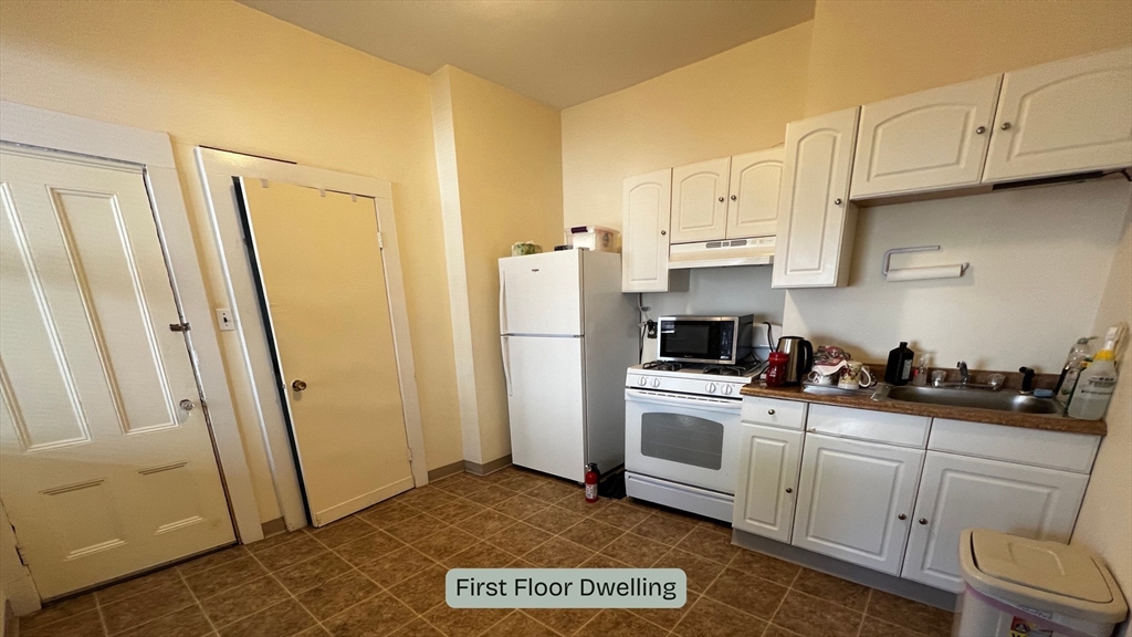 59 Washington Street Boston, MA 02129 - Photo 15 of 15 a kitchen with white cabinets and white appliances