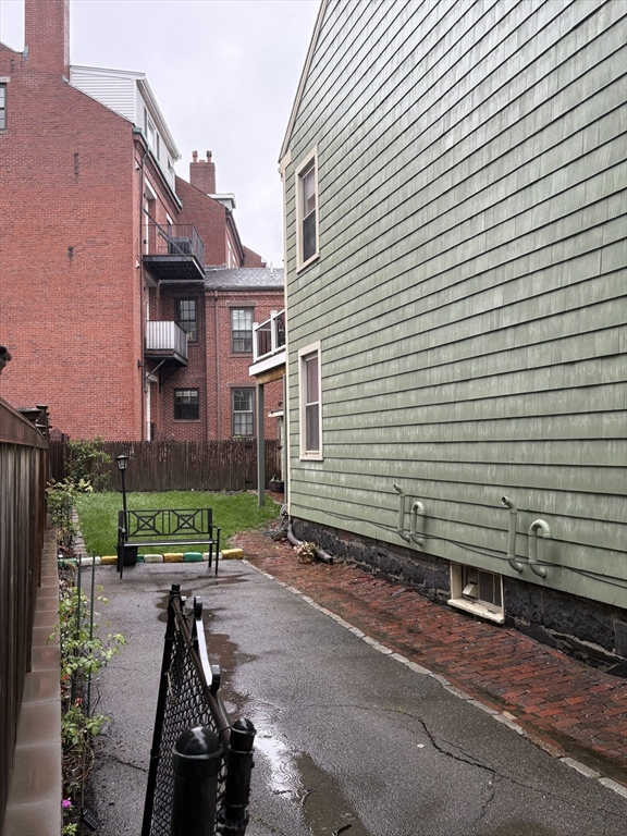 59 Washington Street Boston, MA 02129 - Photo 5 of 15 a view of a brick house with a yard next to a road