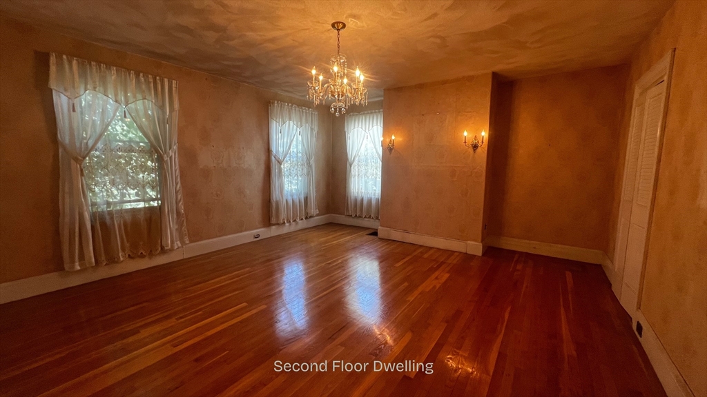 59 Washington Street Boston, MA 02129 - Photo 10 of 15 a view of a room with wooden floor and window