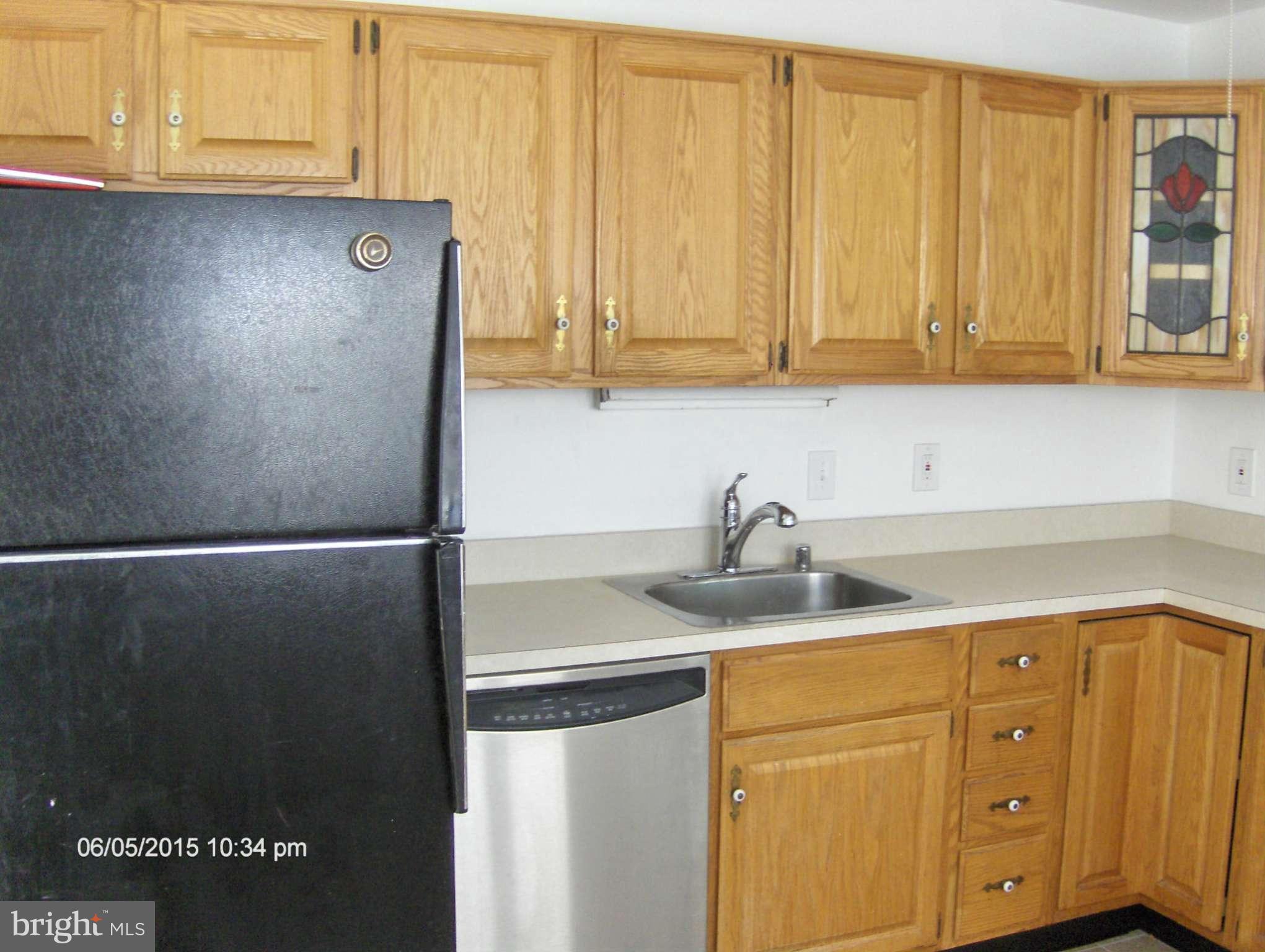 1006 Rosedale Avenue Baltimore, MD 21237 - Photo 7 of 18 a kitchen with a refrigerator and cabinets