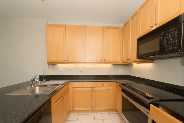 a kitchen with a sink a stove and cabinets