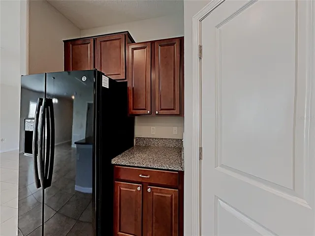 a kitchen with a refrigerator and countertop