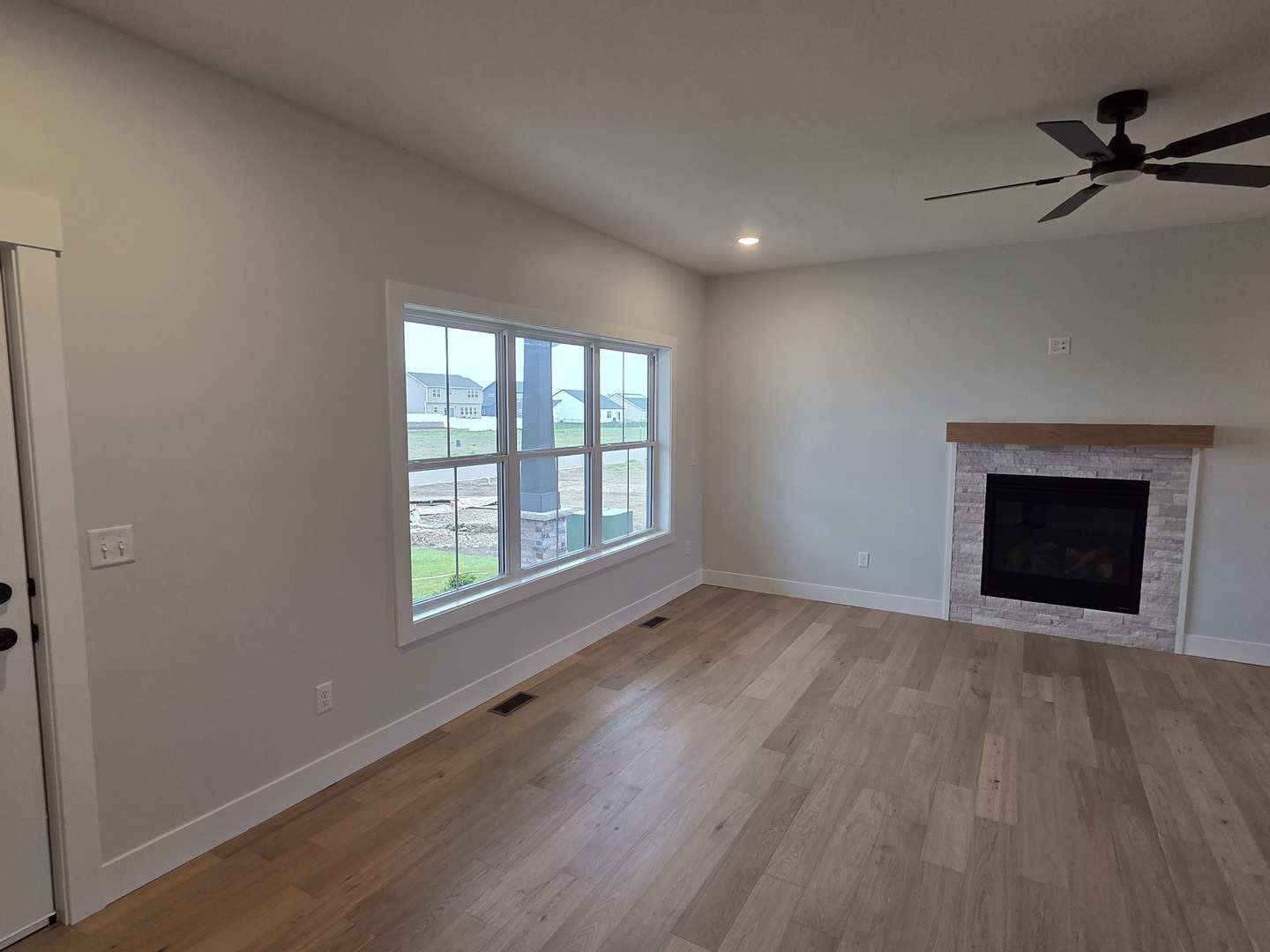2477 Stanfield Lane Normal, IL 61761 - Photo 12 of 48 wooden floor fireplace and natural light in room