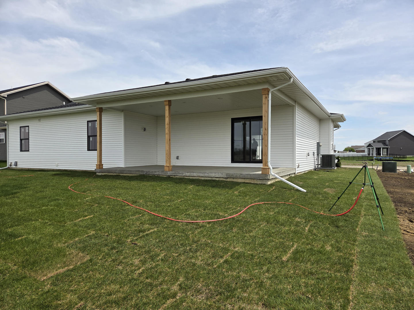 2477 Stanfield Lane Normal, IL 61761 - Photo 34 of 48 a view of a white house with a big yard and potted plants