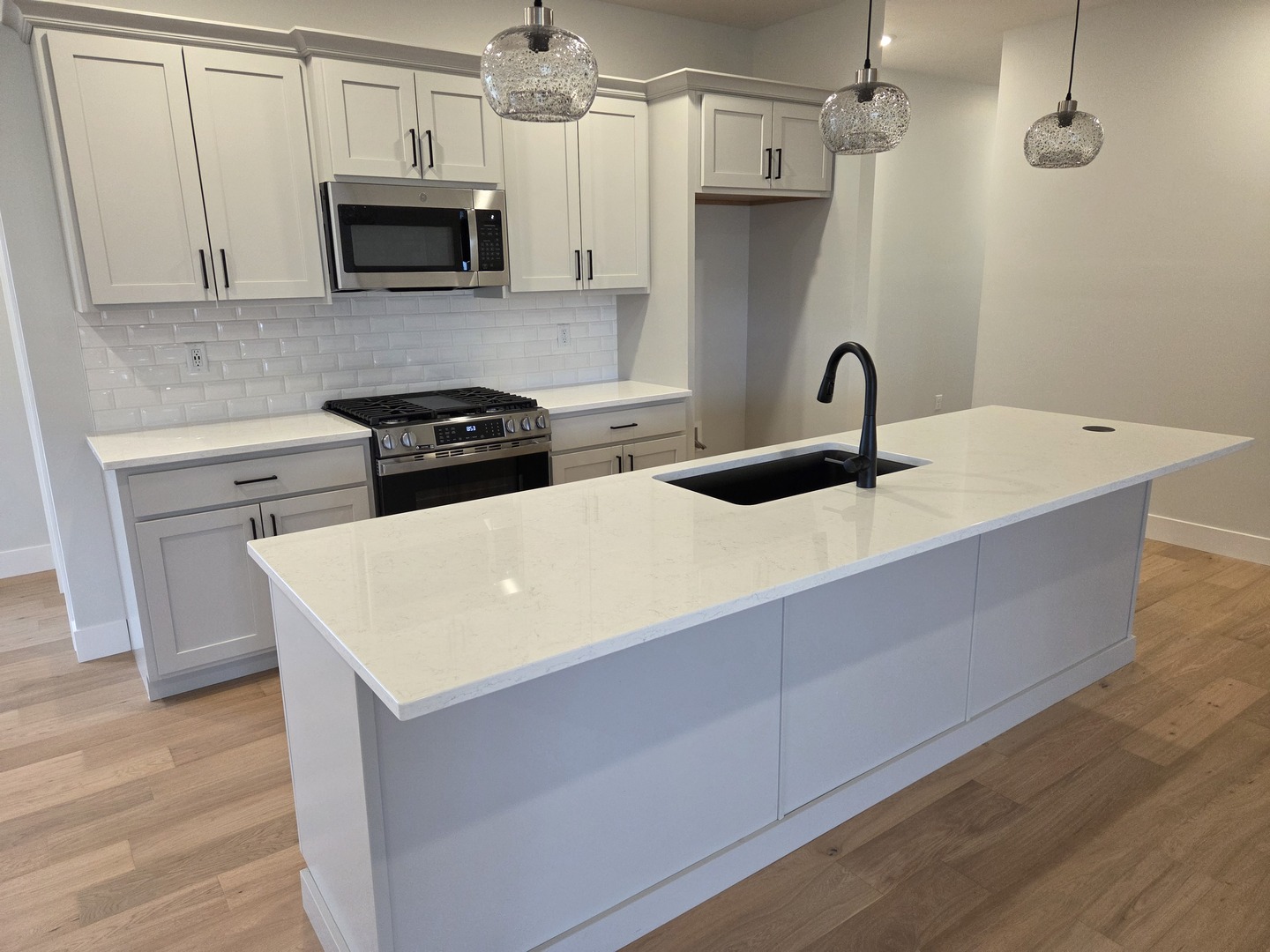2477 Stanfield Lane Normal, IL 61761 - Photo 4 of 48 a kitchen with stainless steel appliances a sink a stove a microwave and wooden cabinets