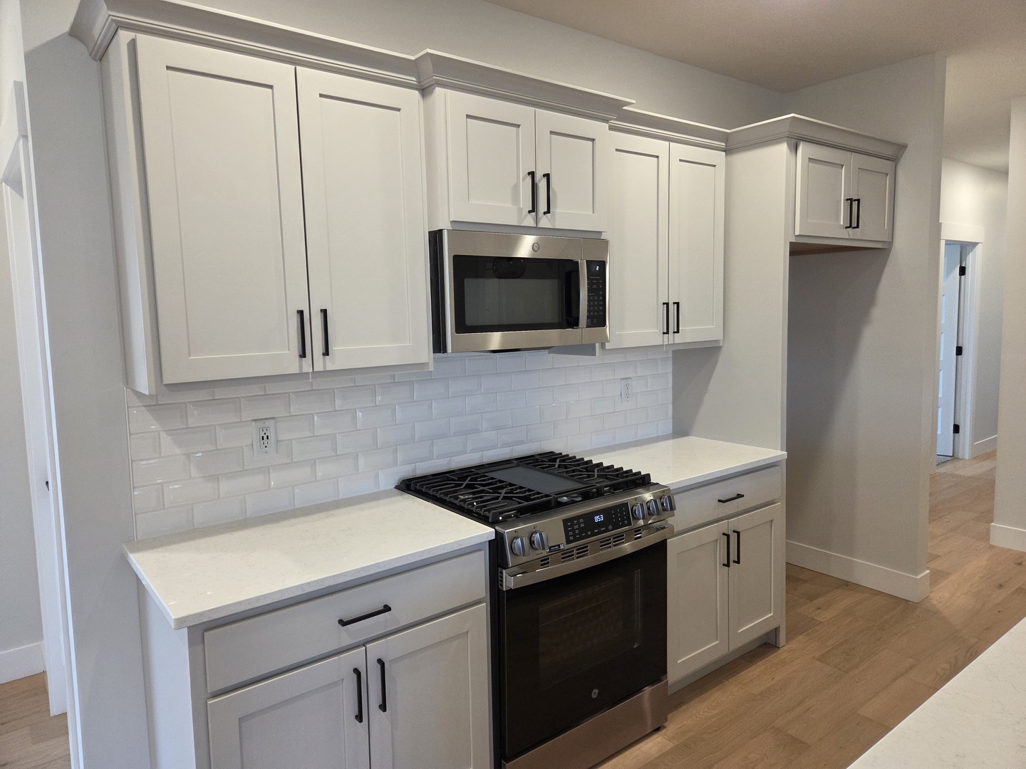 2477 Stanfield Lane Normal, IL 61761 - Photo 5 of 48 a kitchen with white cabinets and black appliances