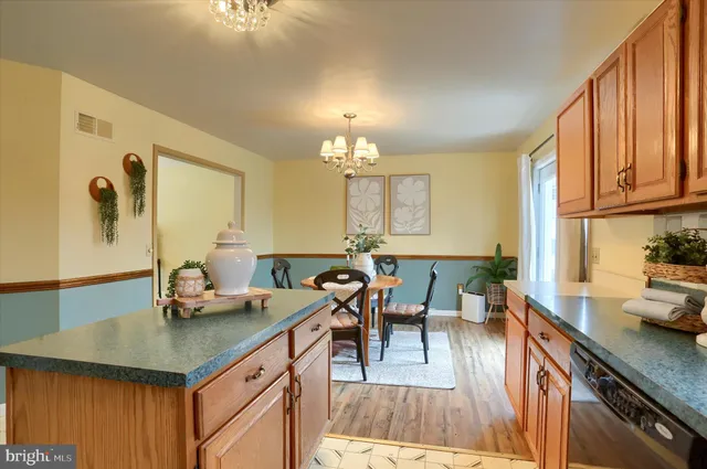a view of a kitchen area with furniture and wooden floor