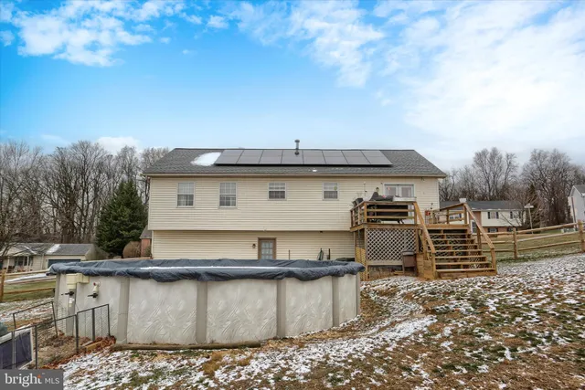 a view of a house with a yard and furniture