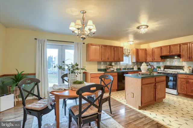 a view of a dining room with furniture and chandelier
