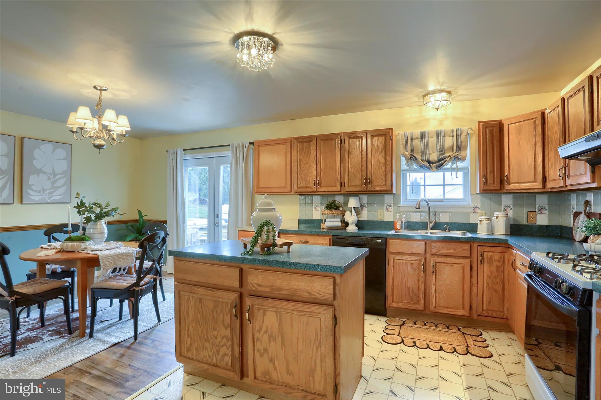 201 Overview Circle West Red Lion, PA 17356 - Photo 10 of 29 a kitchen with a stove a sink a dining table and chairs