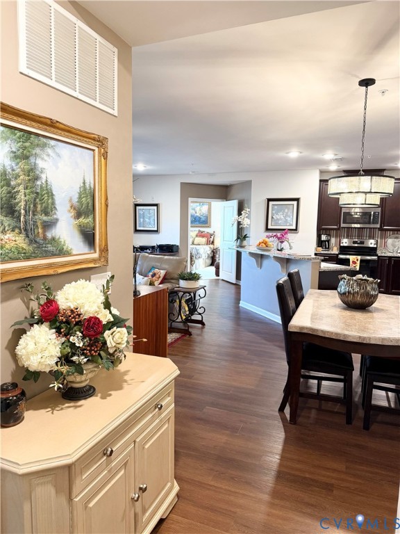 1003 Westwood Village Lane, Unit 303 Midlothian, VA 23114 - Photo 21 of 22 a kitchen with a wooden floor and breakfast area