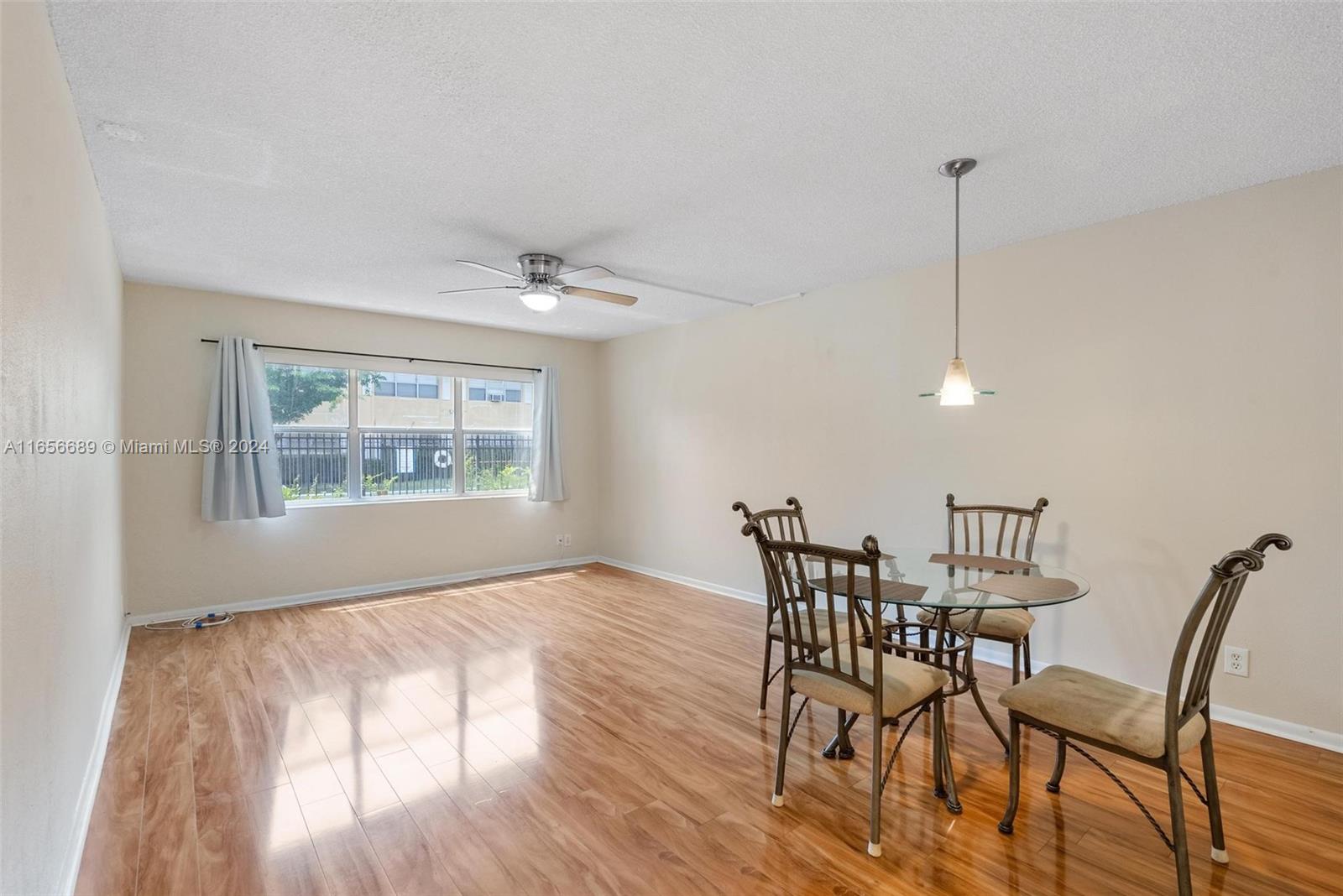 440 Southeast 2nd Avenue, Unit 3 Deerfield Beach, FL 33441 - Photo 1 of 14 a view of a dining room with furniture window and wooden floor