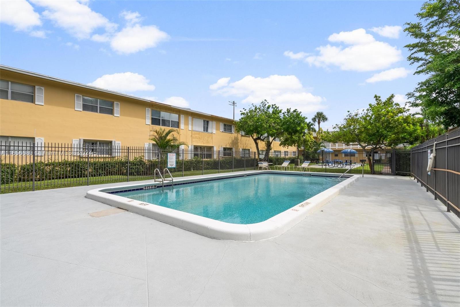 440 Southeast 2nd Avenue, Unit 3 Deerfield Beach, FL 33441 - Photo 11 of 14 a view of a swimming pool with a yard