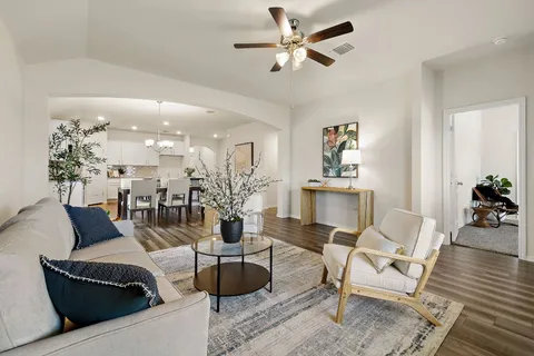 a living room with furniture and a chandelier