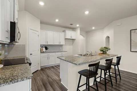a kitchen with a table and chairs in it