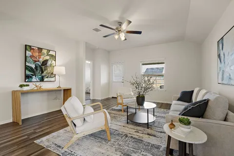 a living room with furniture and wooden floor