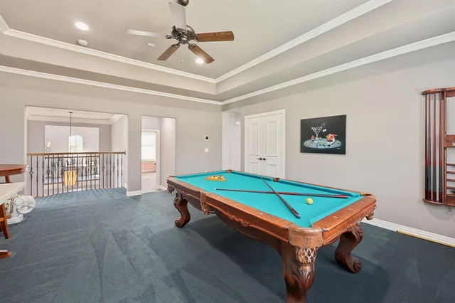 a room with pool table and windows