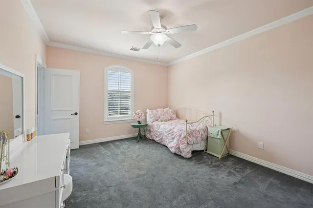 a spacious bedroom with a bed and a window