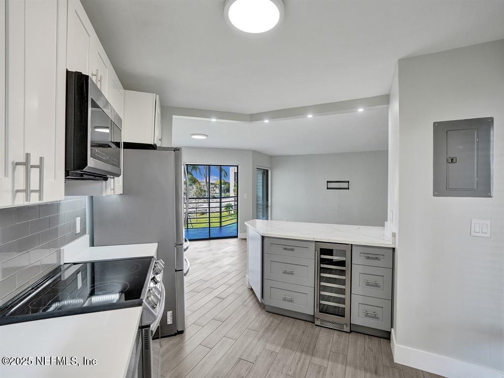 5851 Camino Del Sol, Unit 305 Boca Raton, FL 33433 - Photo 11 of 47 a kitchen with a stove and a sink