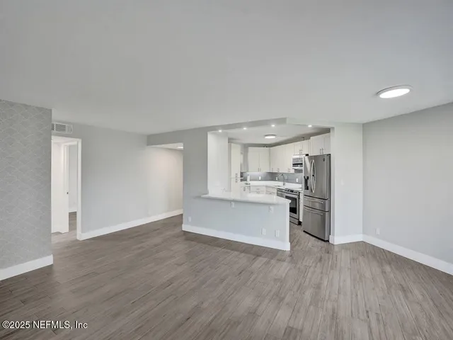 a view of a kitchen with wooden floor