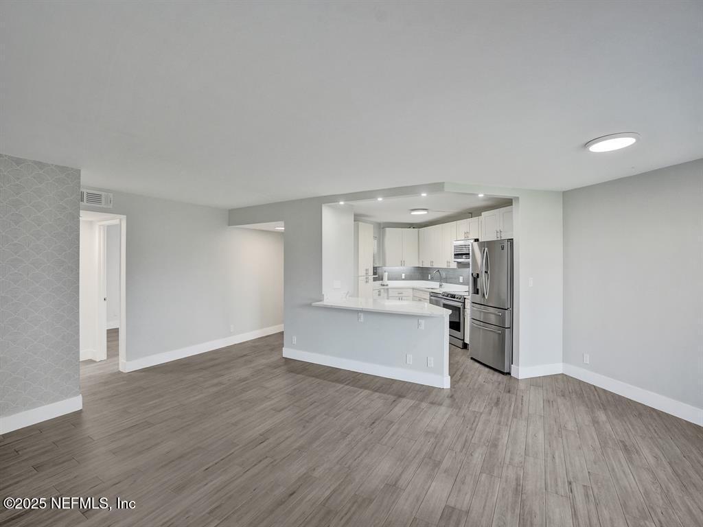 5851 Camino Del Sol, Unit 305 Boca Raton, FL 33433 - Photo 15 of 47 a view of a kitchen with wooden floor