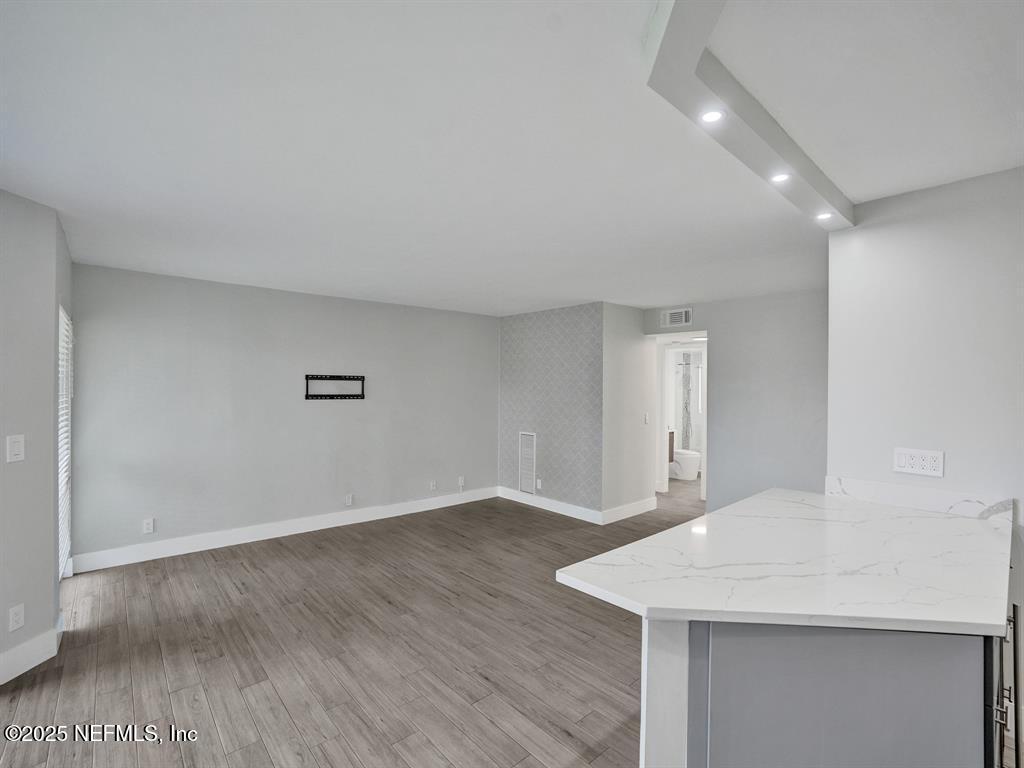 5851 Camino Del Sol, Unit 305 Boca Raton, FL 33433 - Photo 17 of 47 a view of an empty room with wooden floor