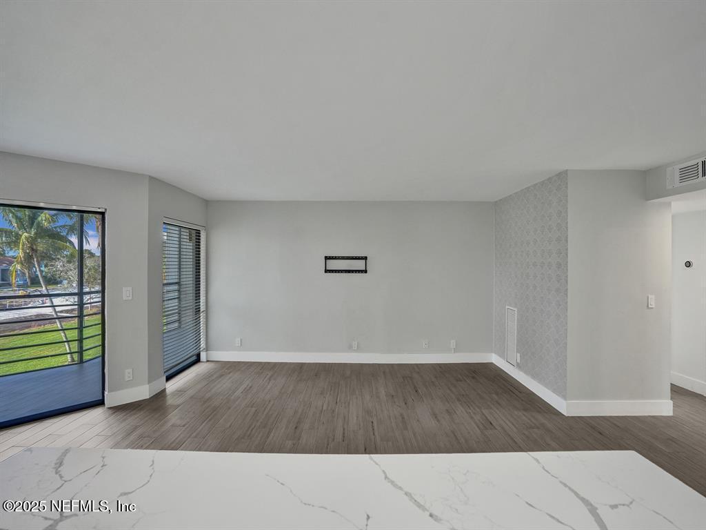5851 Camino Del Sol, Unit 305 Boca Raton, FL 33433 - Photo 19 of 47 wooden floor in an empty room with a window