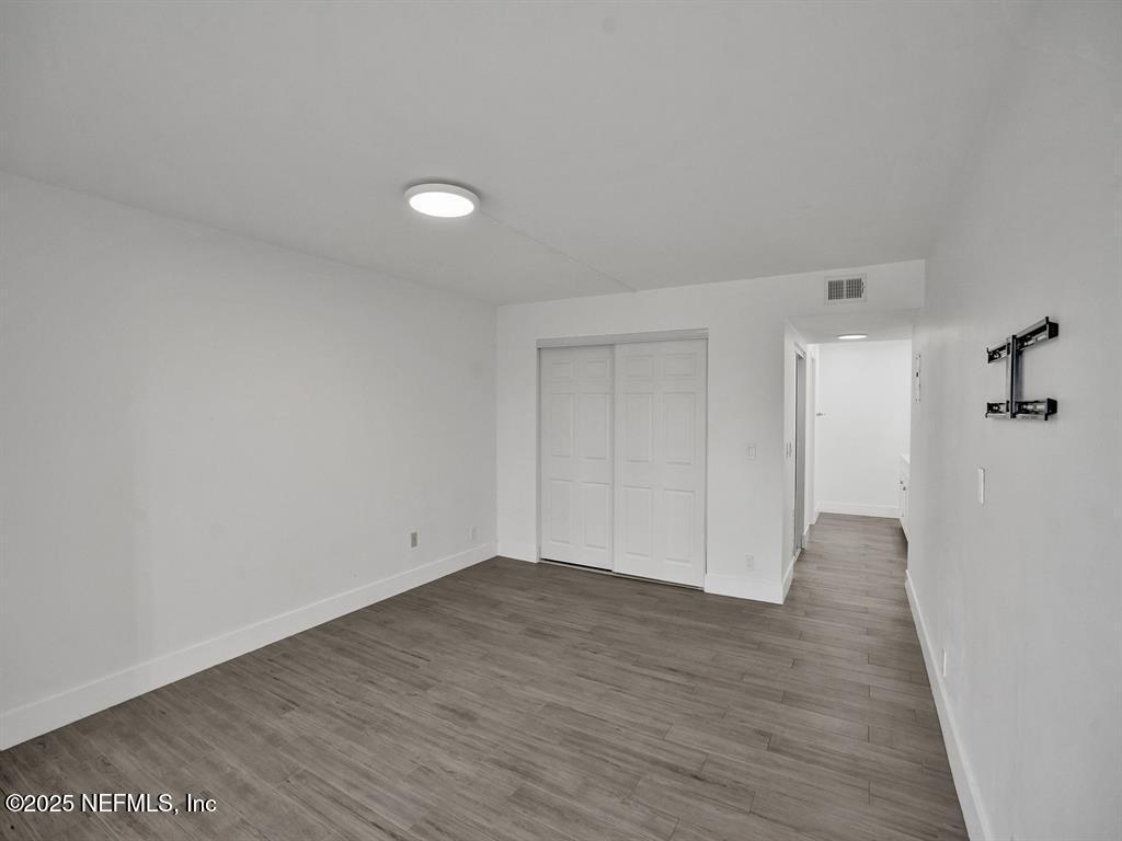 5851 Camino Del Sol, Unit 305 Boca Raton, FL 33433 - Photo 22 of 47 a view of an empty room with wooden floor
